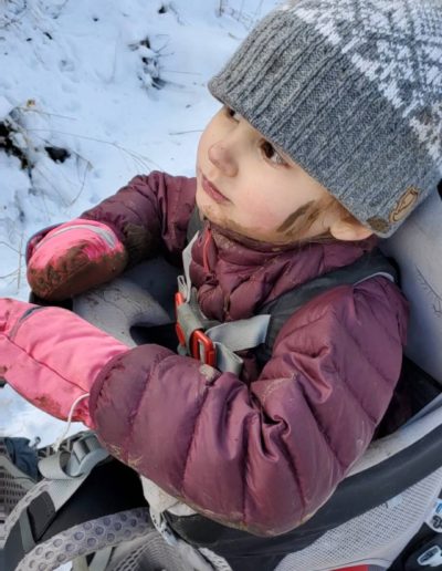 Girl riding in backpack while hiking