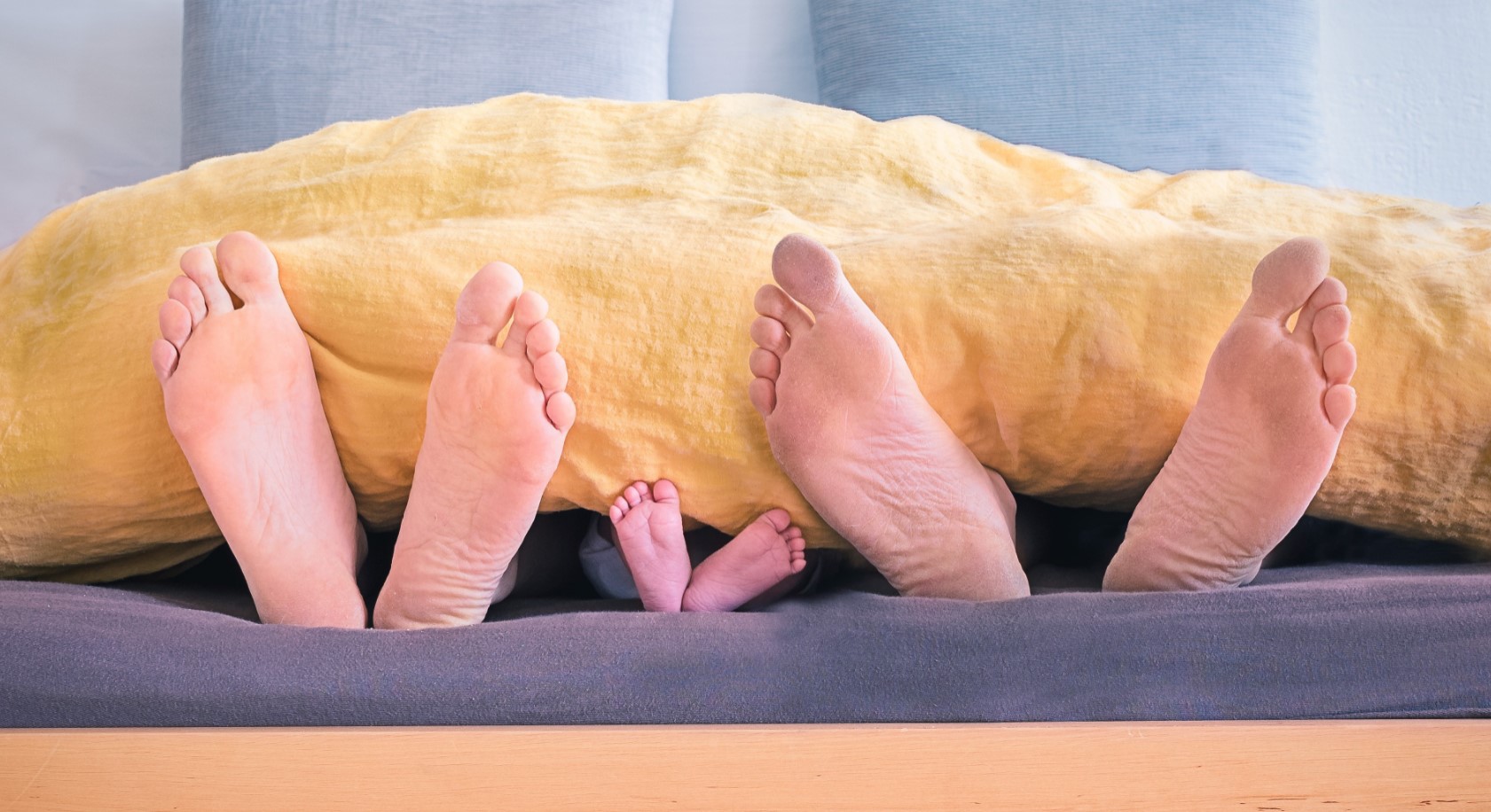 Family of Feet in Bed