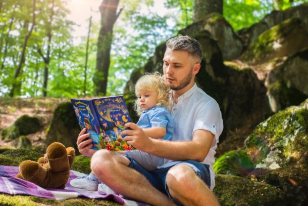 photo-of-father-and-child-reading-book-during-daytime